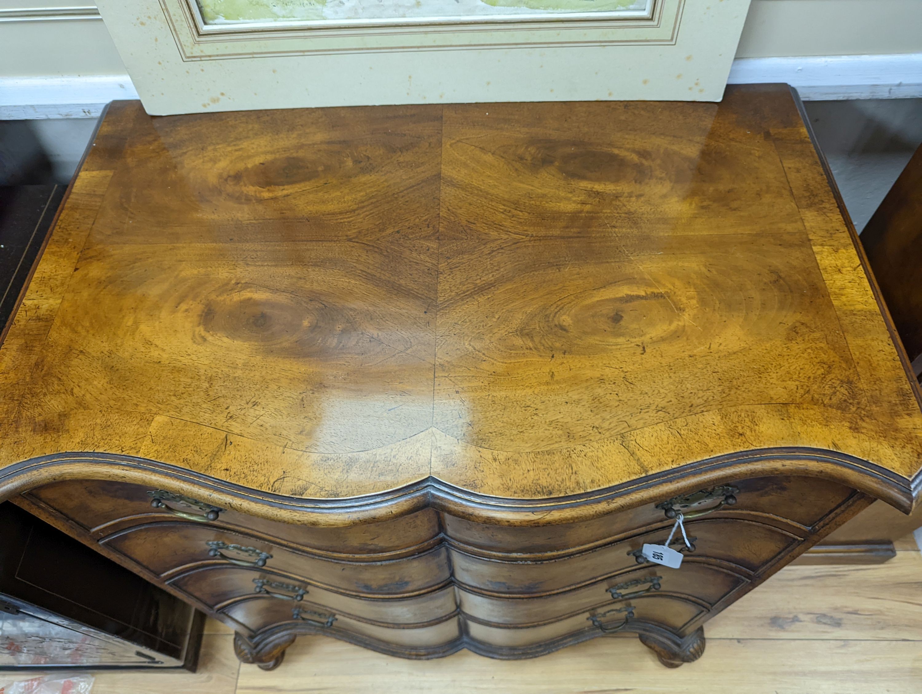 A 1920's Queen Anne revival banded walnut shaped front chest, width 76cm, depth 46cm, height 85cm